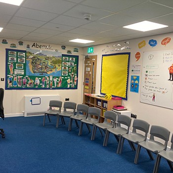row of grey chairs in the classroom