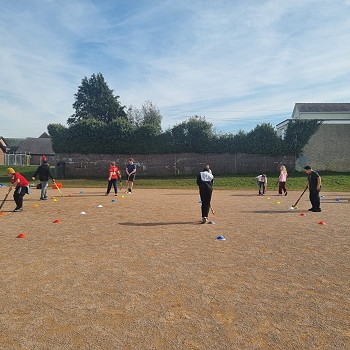 students practising hockey