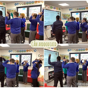group of students following a song on the white board